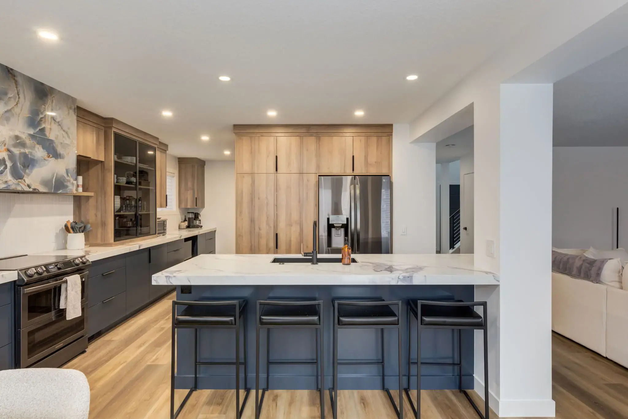 Modern kitchen with navy island and natural wood